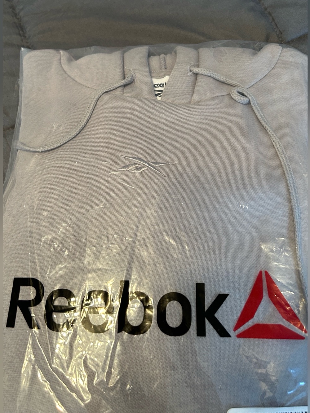 Reebok New in bag grey hoodie.  Size medium.
